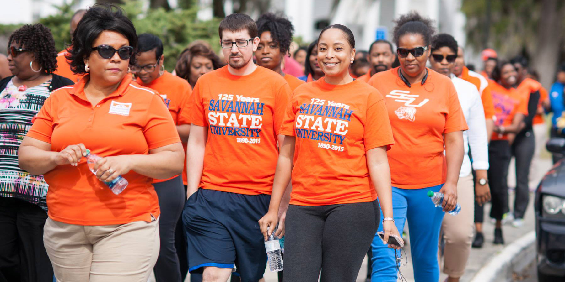 Savannah State University employees participating in a campus fitness walk.